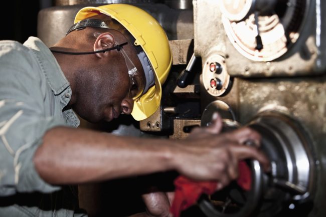 African American worker using drill press recruit, hire, and retain employees